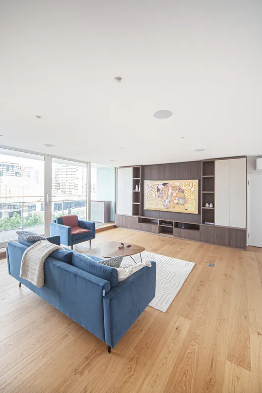 Bright London living room with a fluted timber media wall