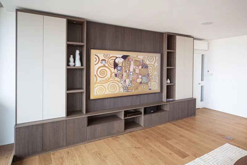 Side view of fluted media unit with painted tall cupboards