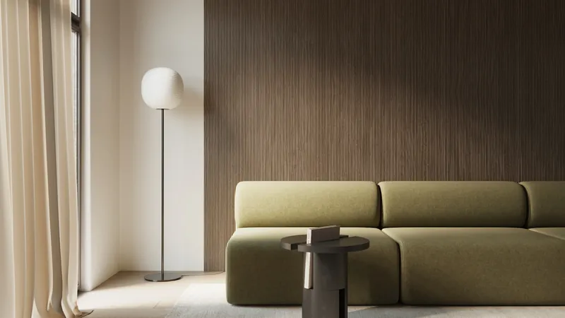 Living room with full-height walnut fluted wall panelling behind a green sofa