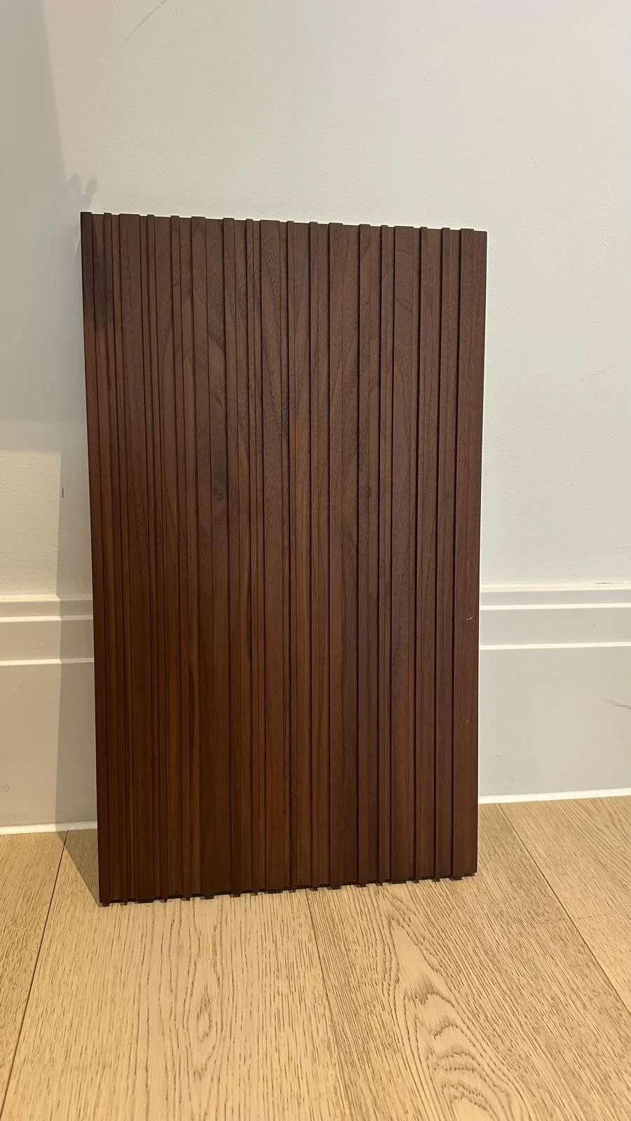 American walnut fluted panel standing vertically with real dark timber grain