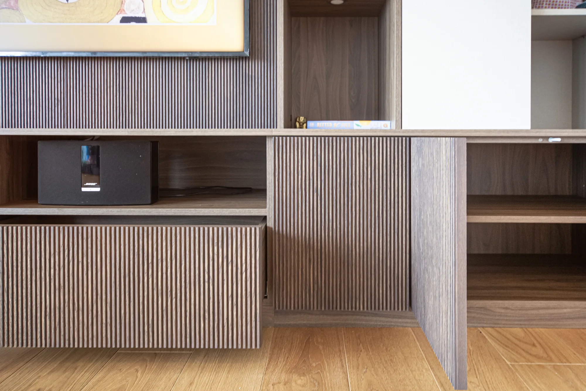 Finished American walnut fluted fitted cabinetry in a London interior
