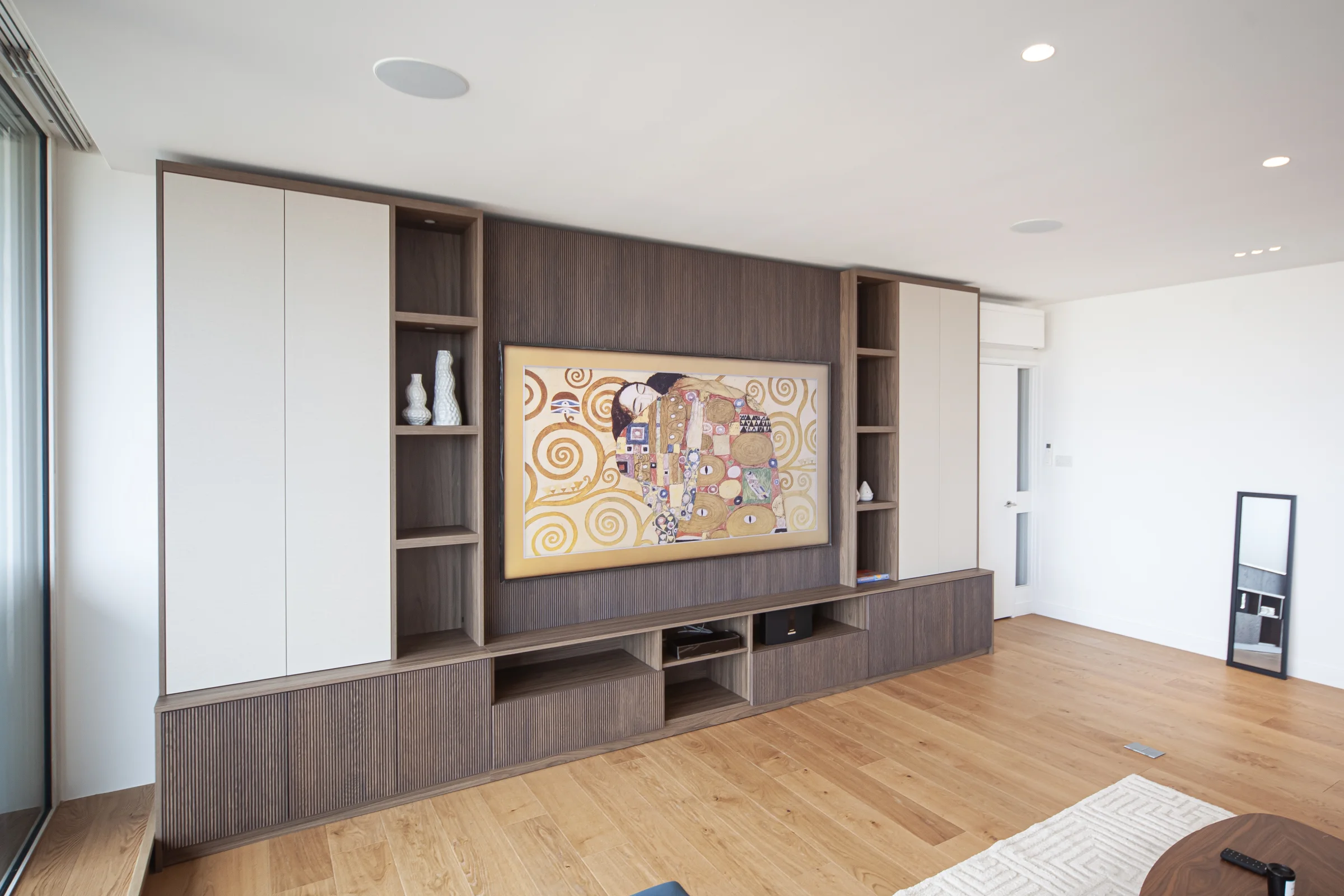 Completed American walnut fluted media wall joinery in London SW1E